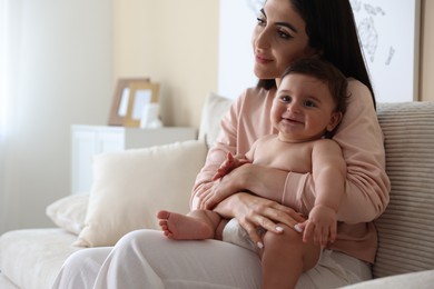 Photo of Happy mother with her cute little baby at home, space for text