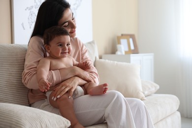 Photo of Happy mother with her cute little baby at home, space for text