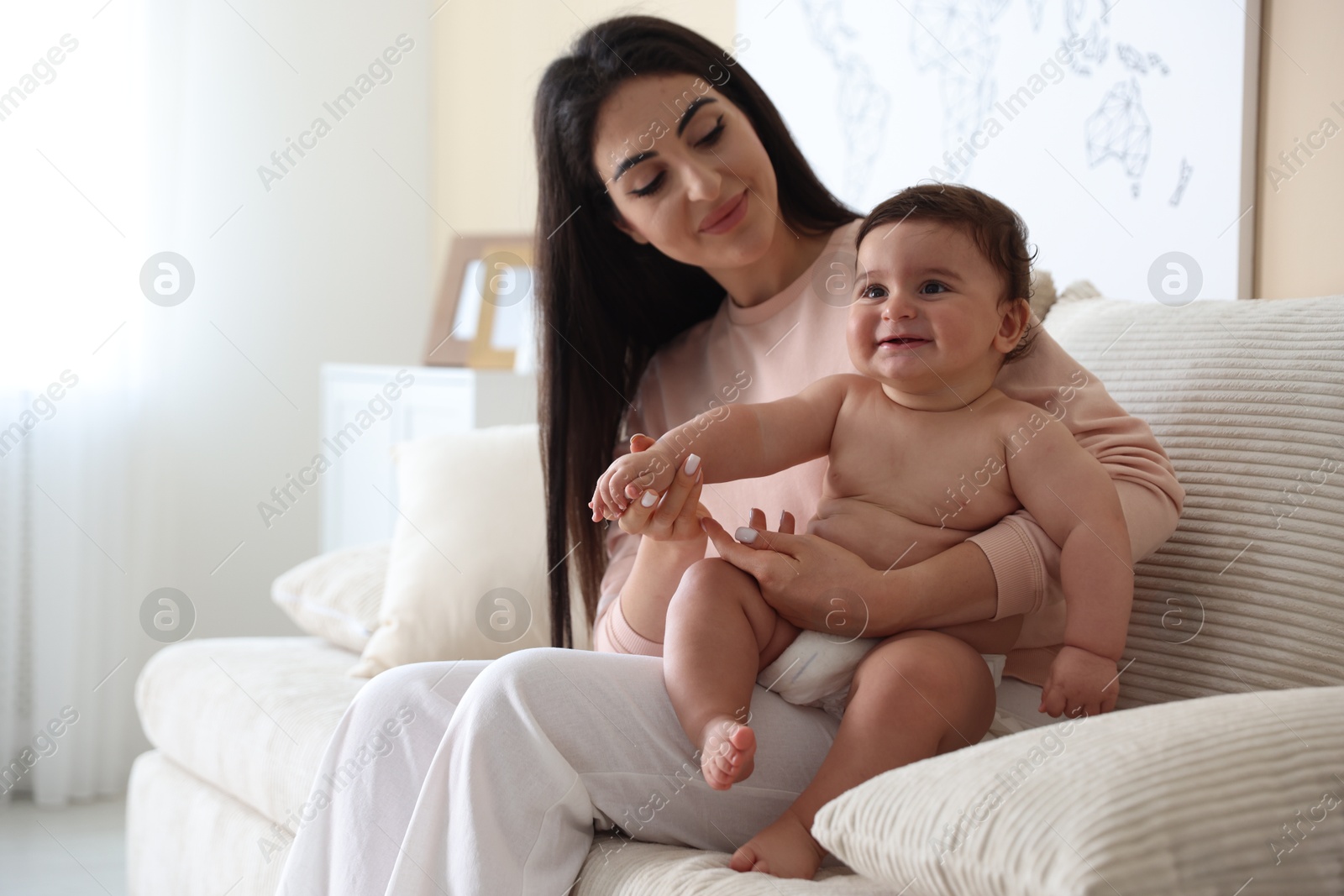 Photo of Happy mother with her cute little baby at home, space for text
