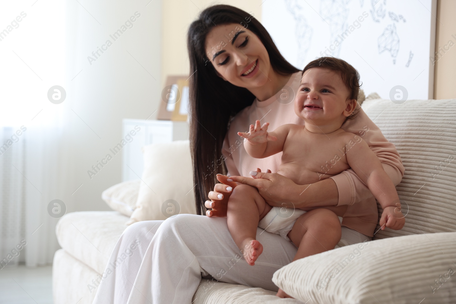 Photo of Happy mother with her cute little baby at home, space for text