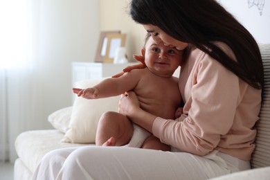 Photo of Happy mother with her cute little baby at home