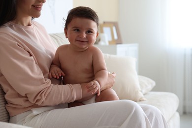 Photo of Happy mother with her cute little baby at home, closeup. Space for text