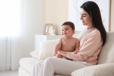 Photo of Happy mother with her cute little baby at home, space for text