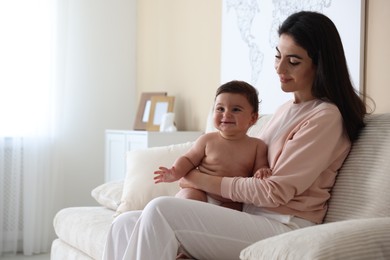 Photo of Happy mother with her cute little baby at home, space for text