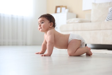 Photo of Cute little baby crawling on floor at home