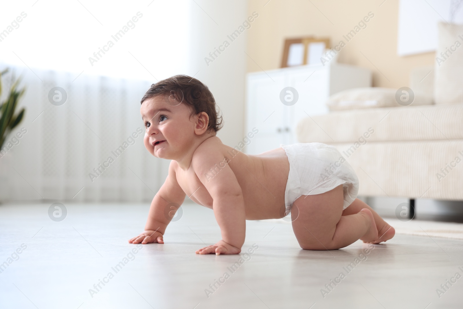 Photo of Cute little baby crawling on floor at home