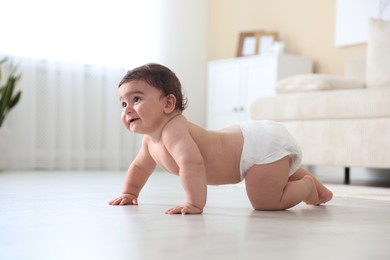 Photo of Cute little baby crawling on floor at home