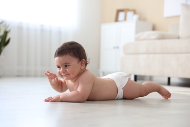 Photo of Cute little baby crawling on floor at home