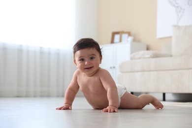 Photo of Cute little baby crawling on floor at home