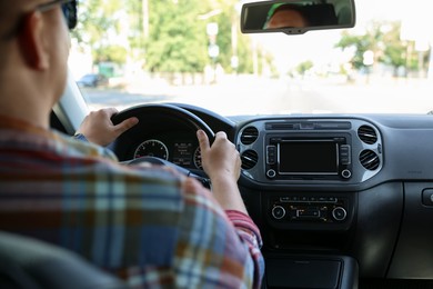 Photo of Man driving car with steering wheel, closeup