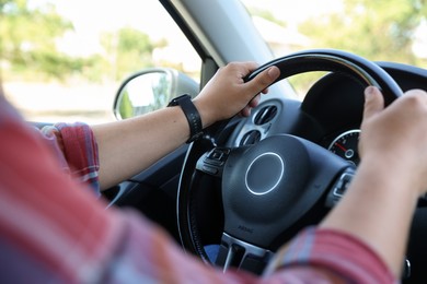 Photo of Man driving car with steering wheel, closeup