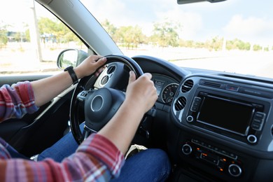 Photo of Man driving car with steering wheel, closeup