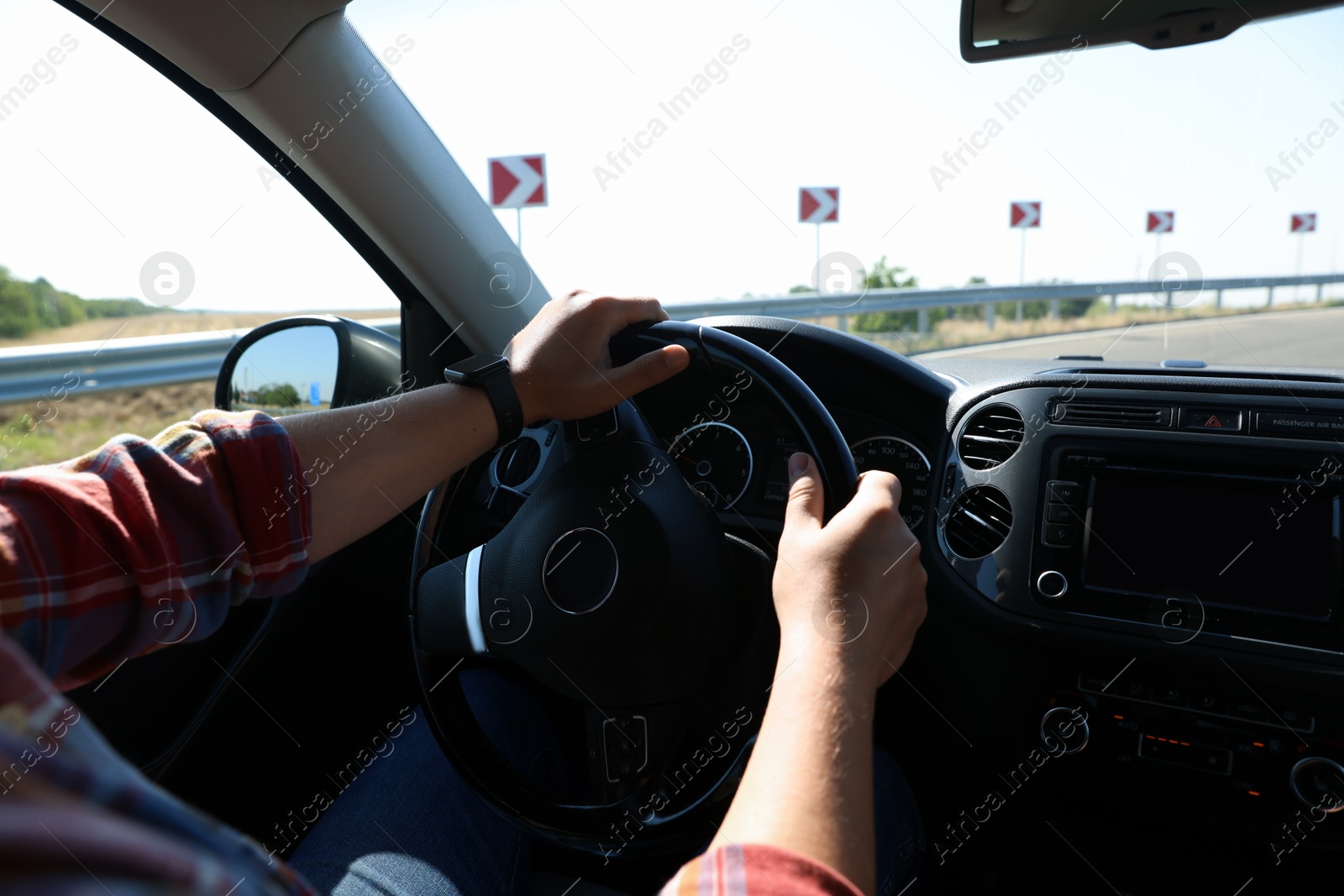 Man driving car with steering wheel, closeup Photo of Man driving car with steering wheel, closeup