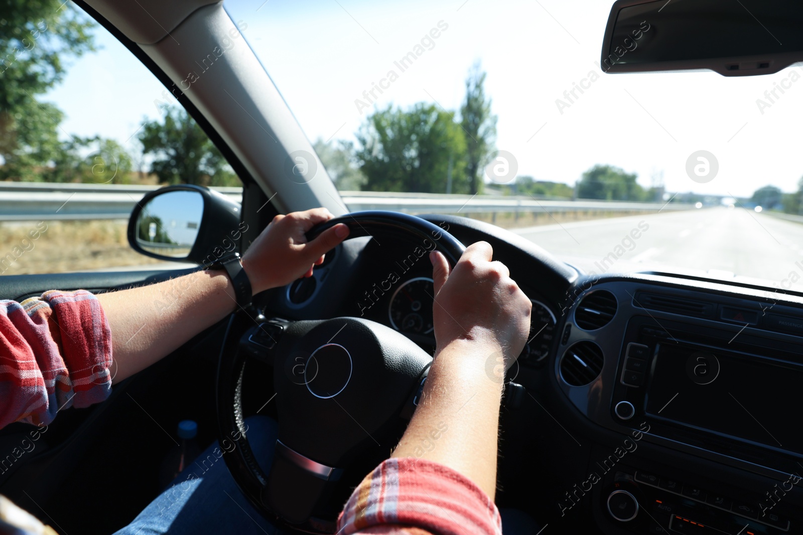 Man driving car with steering wheel, closeup Photo of Man driving car with steering wheel, closeup
