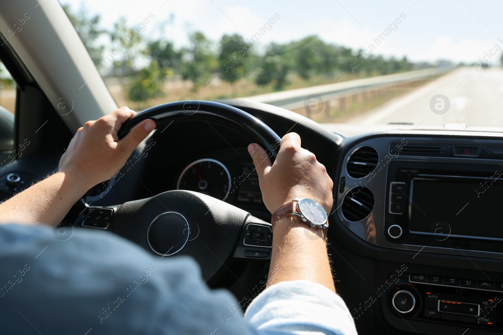 Man driving car with steering wheel, closeup Photo of Man driving car with steering wheel, closeup