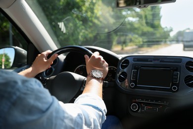 Photo of Man driving car with steering wheel, closeup
