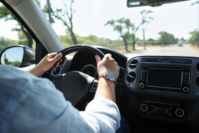 Photo of Man driving car with steering wheel, closeup