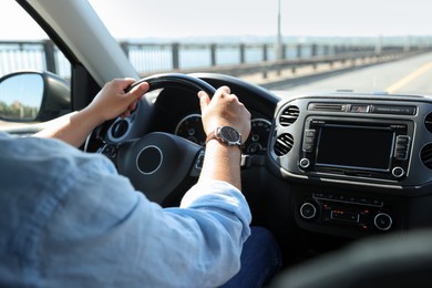 Photo of Man driving car with steering wheel, closeup