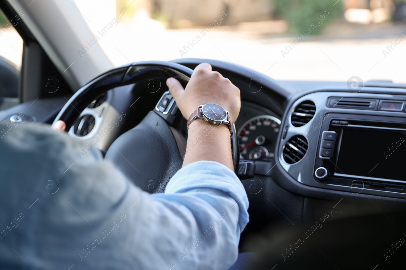 Man driving car with steering wheel, closeup Photo of Man driving car with steering wheel, closeup