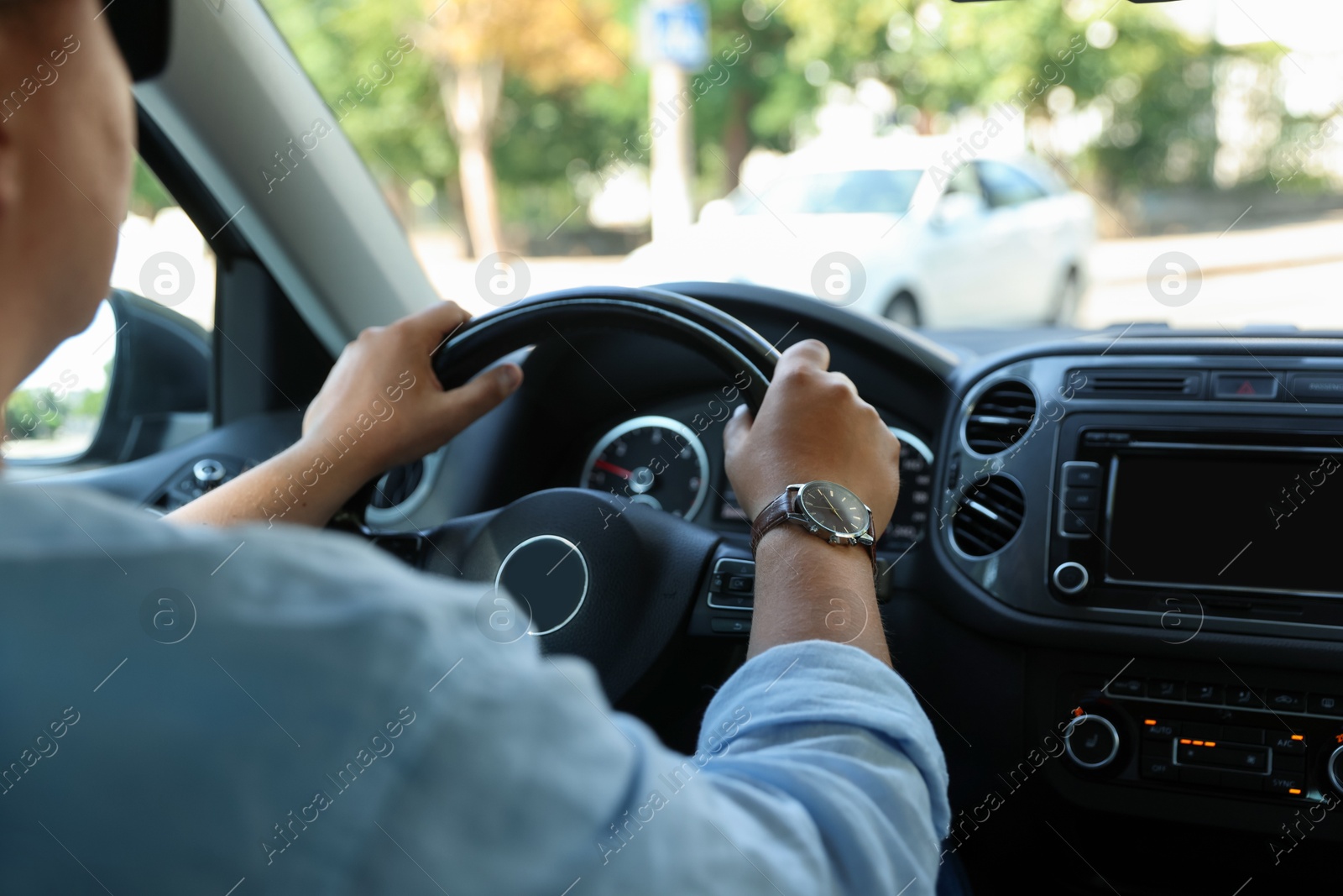 Man driving car with steering wheel, closeup Photo of Man driving car with steering wheel, closeup