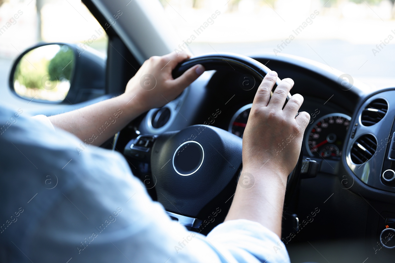 Man driving car with steering wheel, closeup Photo of Man driving car with steering wheel, closeup