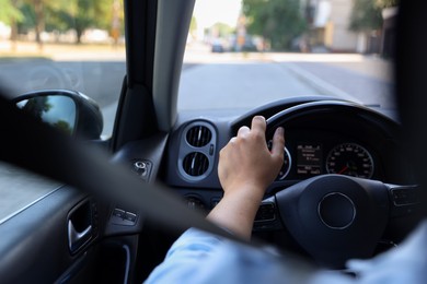 Photo of Man driving car with steering wheel, closeup