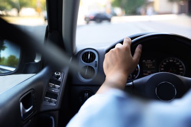 Photo of Man driving car with steering wheel, closeup