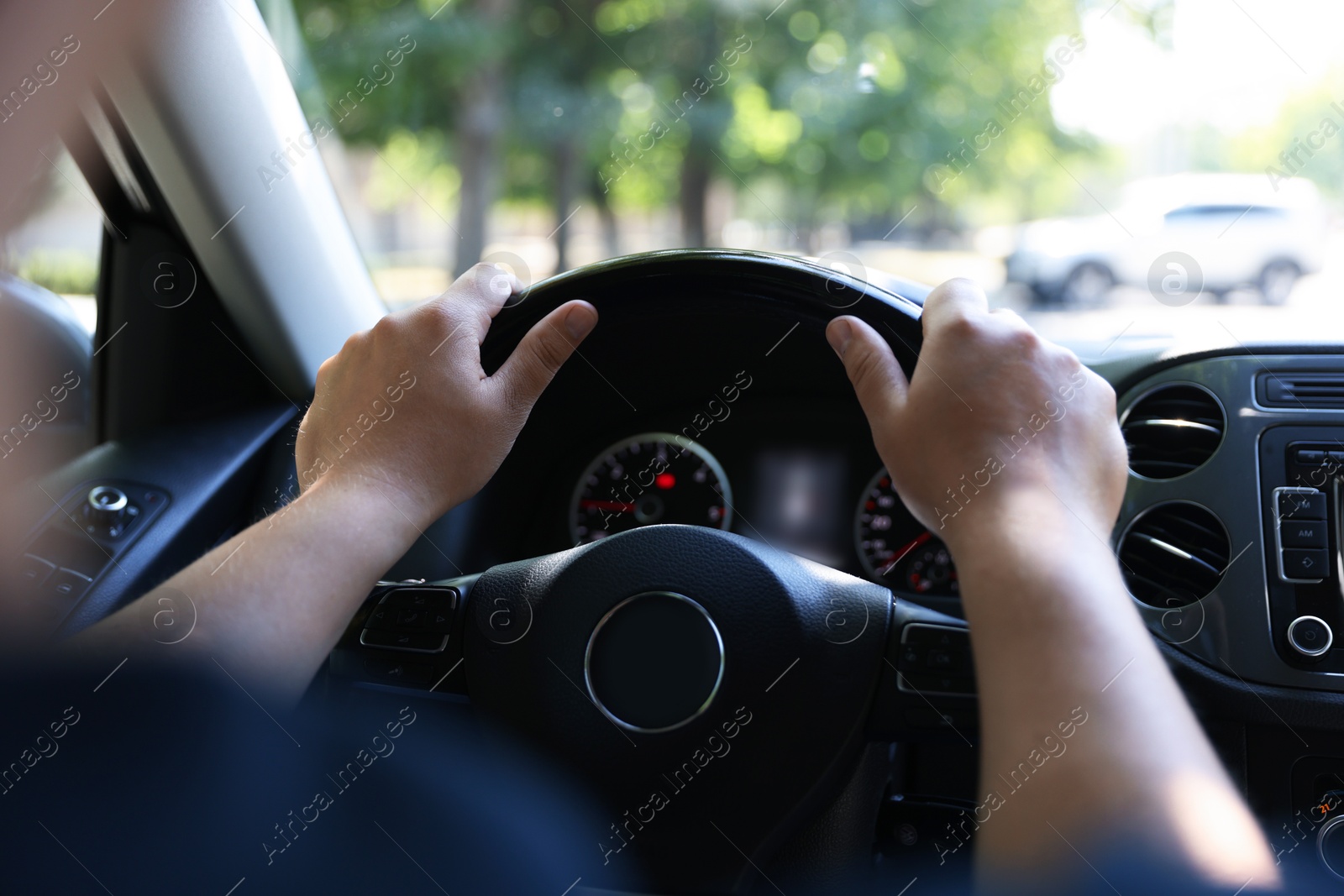 Man driving car with steering wheel, closeup Photo of Man driving car with steering wheel, closeup