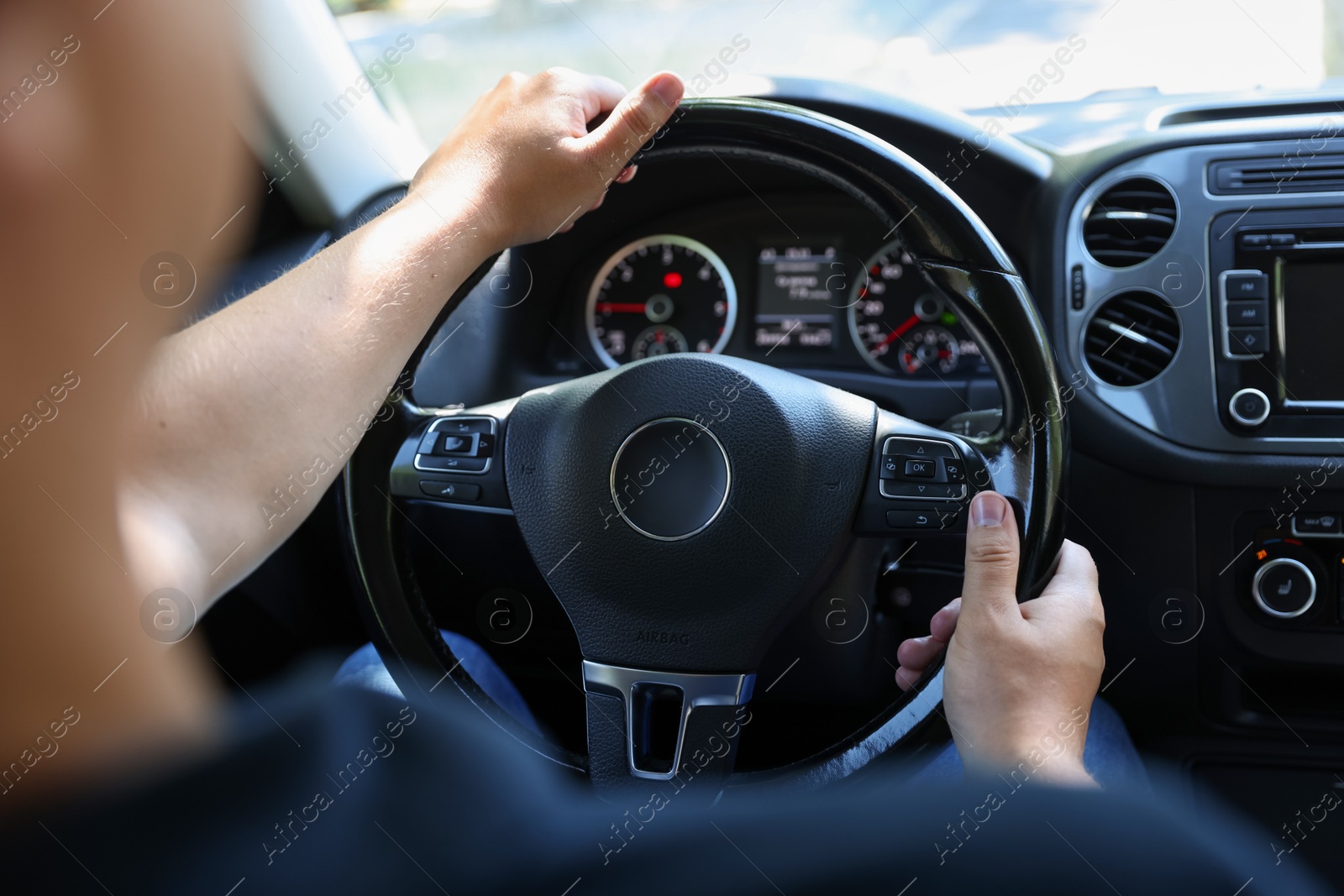 Man driving car with steering wheel, closeup Photo of Man driving car with steering wheel, closeup