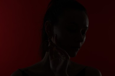 Photo of Silhouette of woman on dark red background