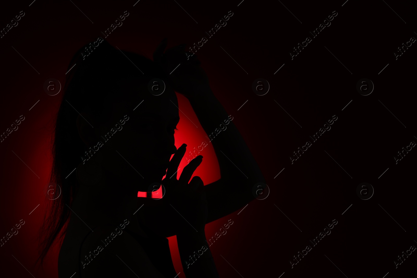 Silhouette of woman on dark background, space for text Photo of Silhouette of woman on dark background, space for text