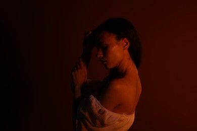 Photo of Woman in dress on dark brown background