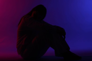 Photo of Silhouette of woman on bright color background