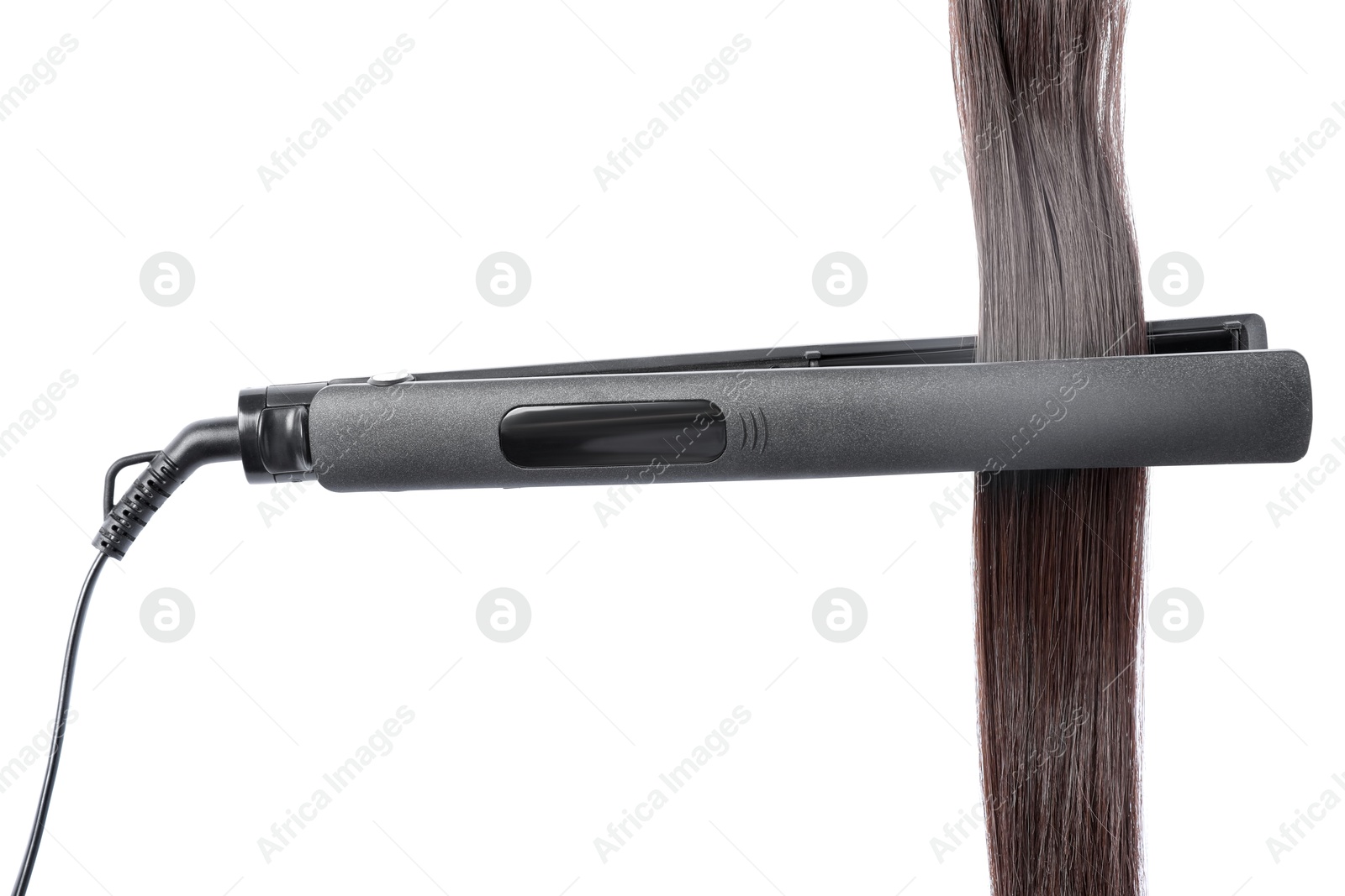 Straightener with brown hair lock isolated on white Photo of Straightener with brown hair lock isolated on white