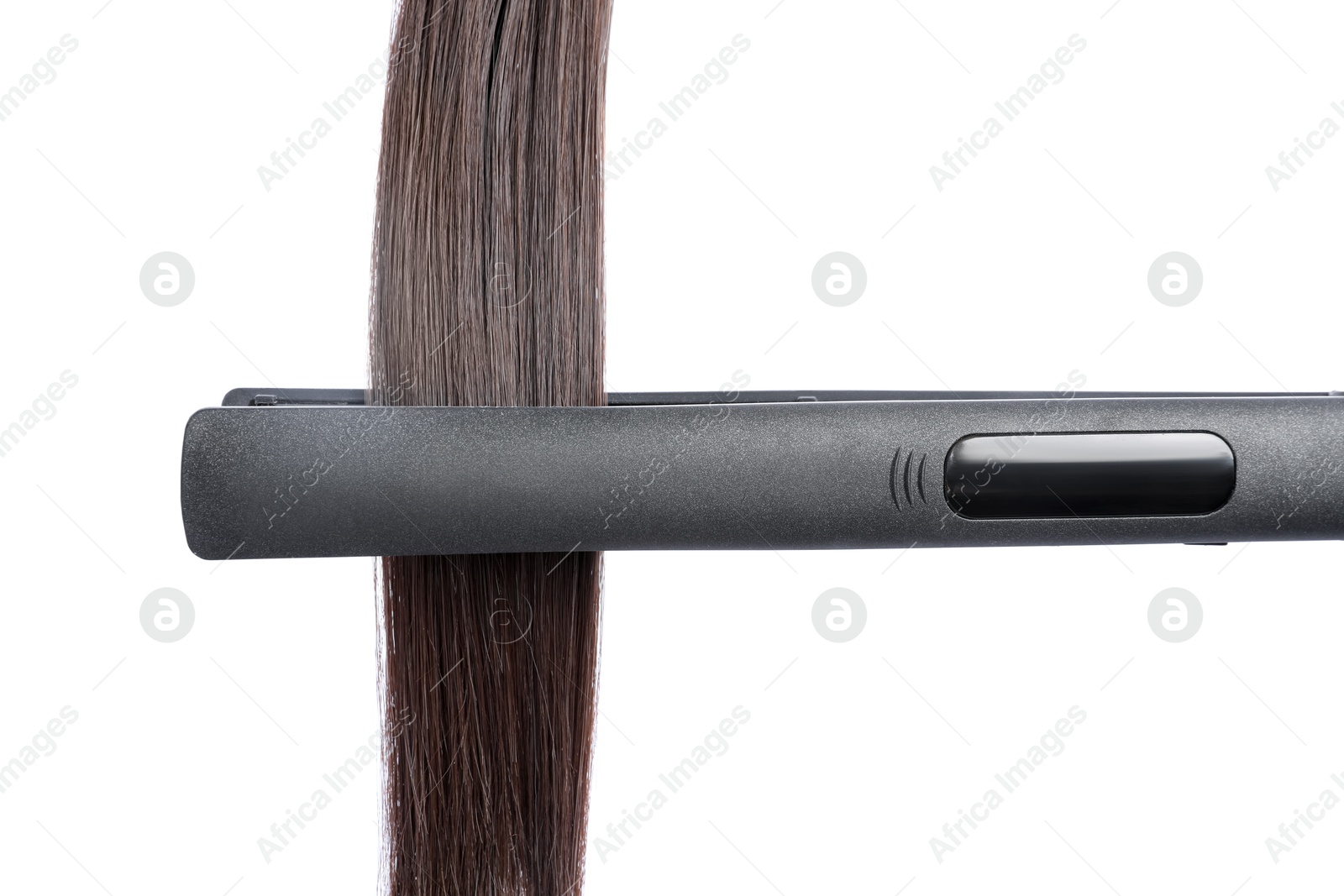 Photo of Straightener with brown hair lock isolated on white