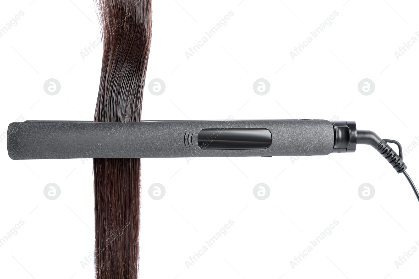 Photo of Straightener with brown hair lock isolated on white