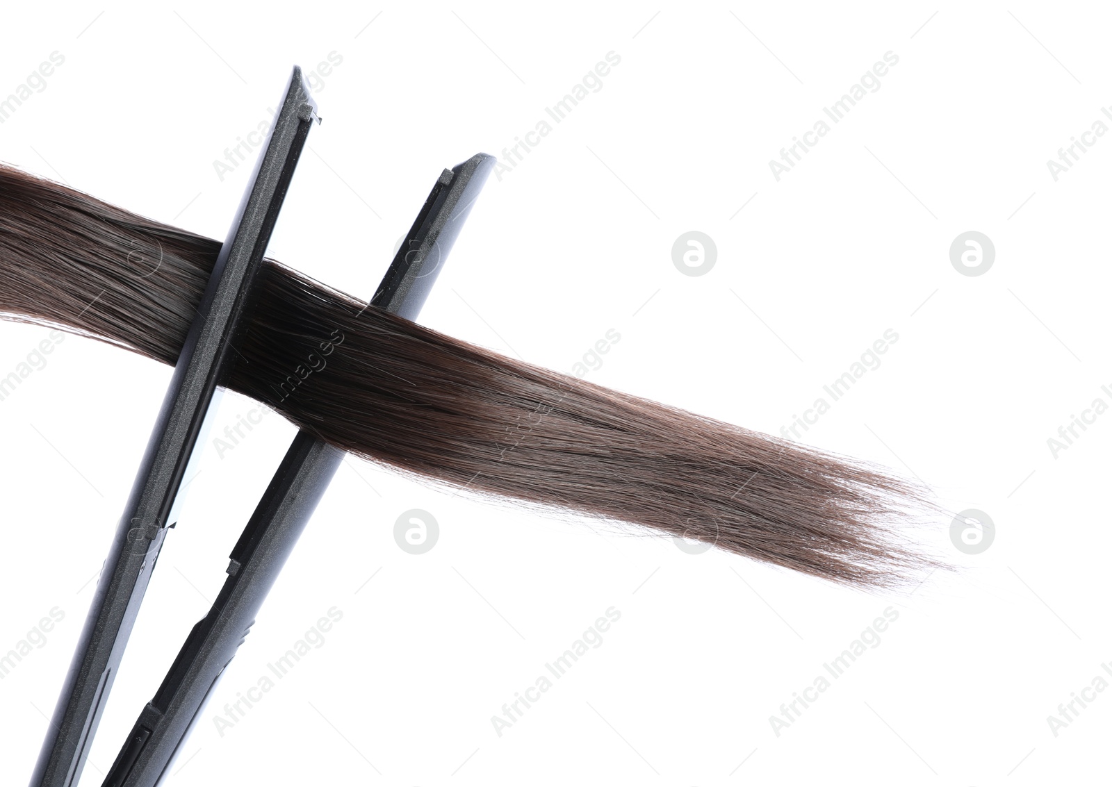 Straightener with brown hair lock isolated on white Photo of Straightener with brown hair lock isolated on white