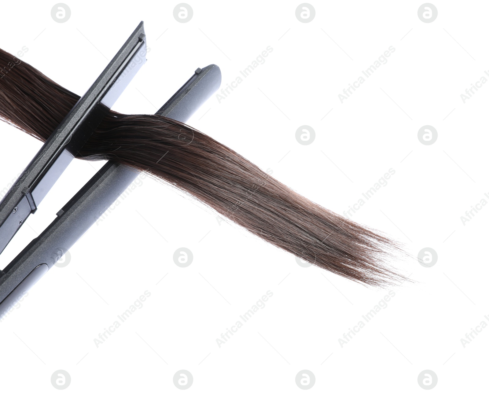 Straightener with brown hair lock isolated on white Photo of Straightener with brown hair lock isolated on white