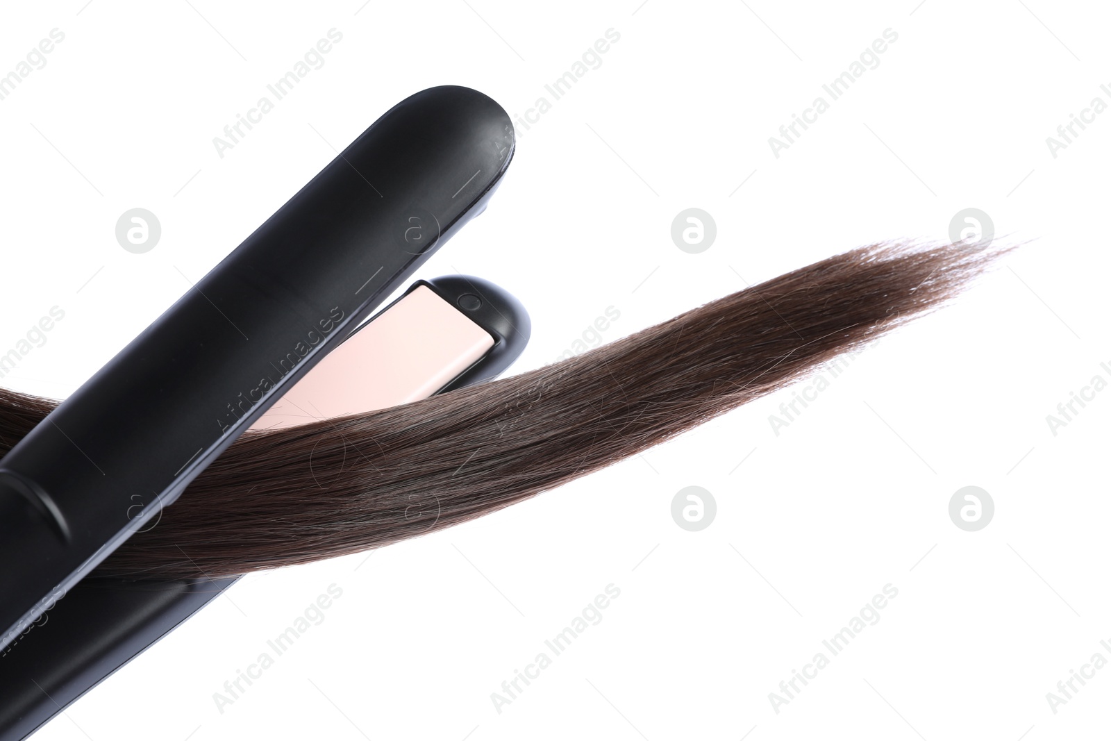 Photo of Straightener with brown hair lock isolated on white