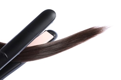 Photo of Straightener with brown hair lock isolated on white