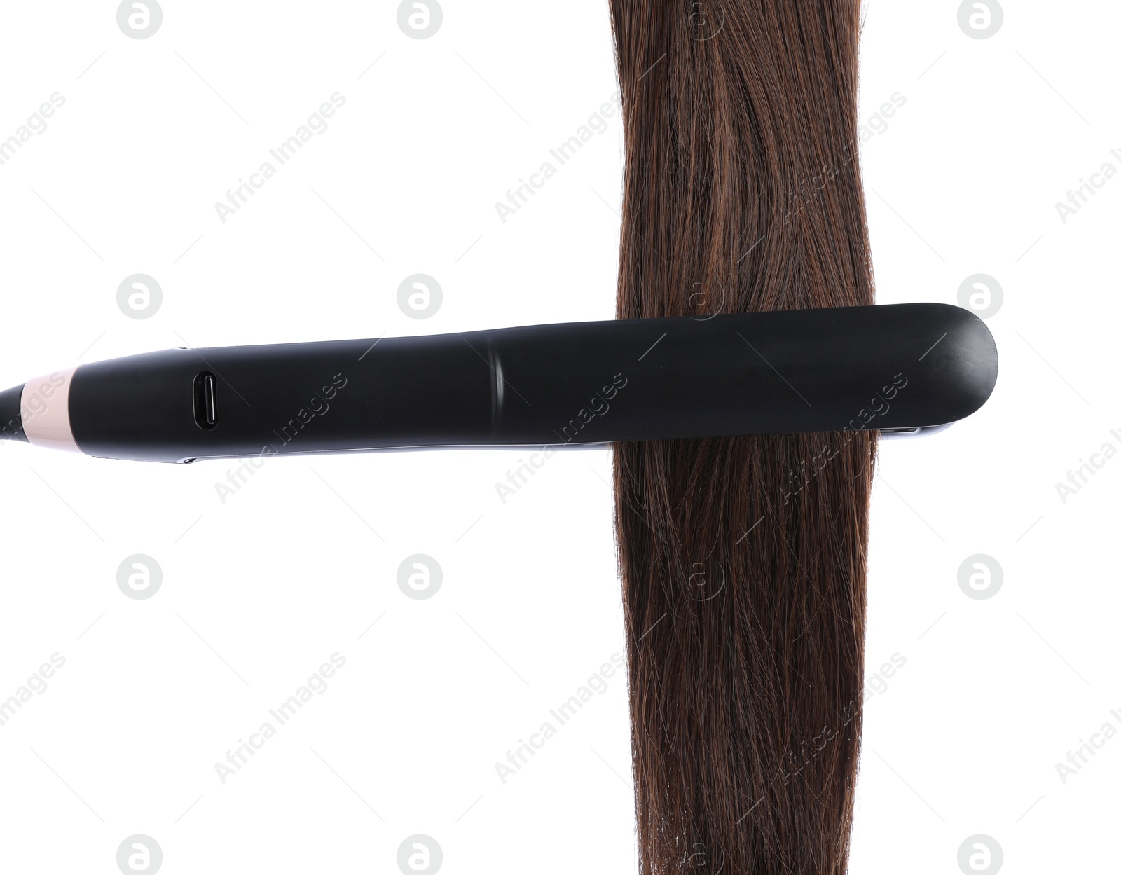 Straightener with brown hair lock isolated on white Photo of Straightener with brown hair lock isolated on white