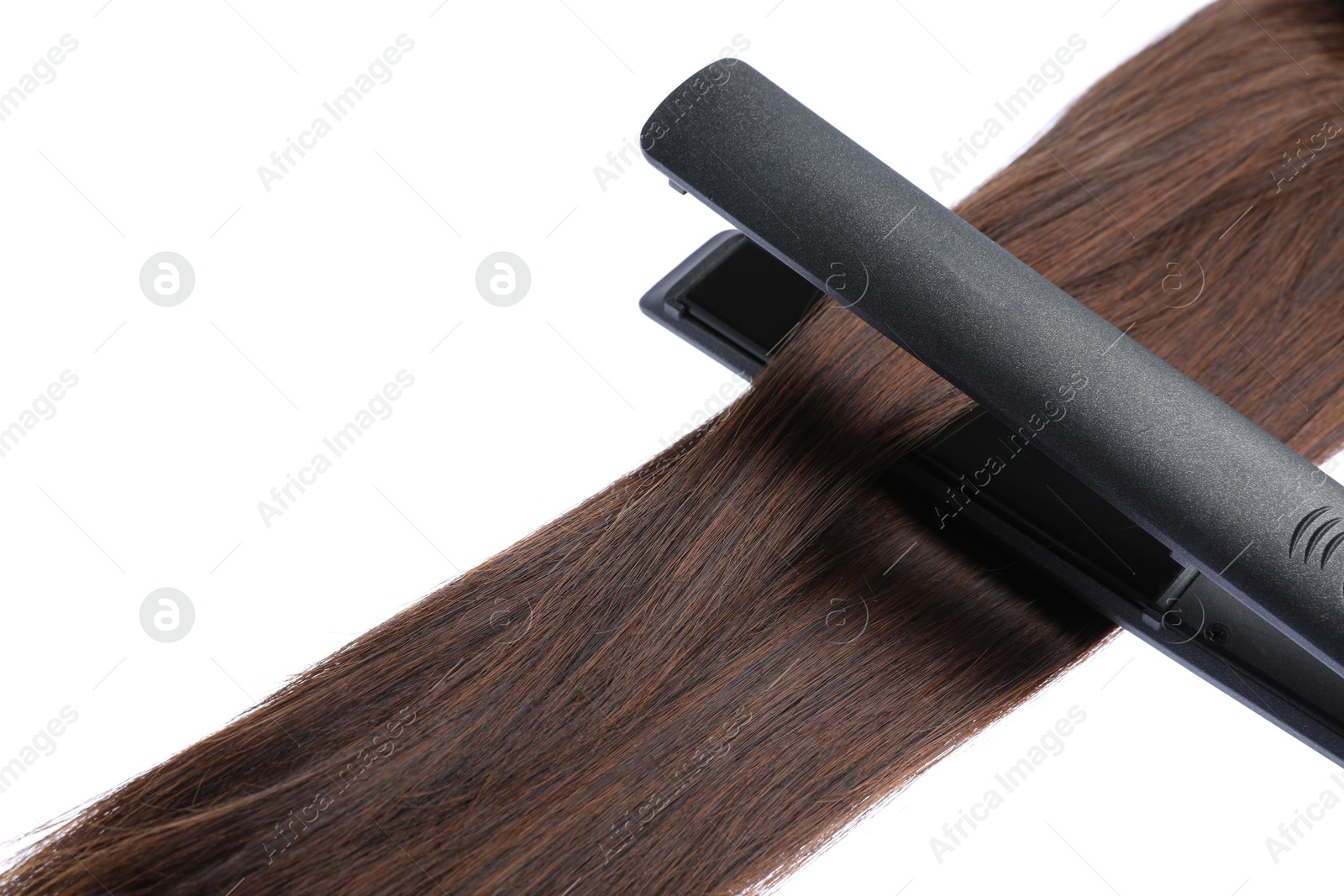 Straightener with brown hair lock isolated on white Photo of Straightener with brown hair lock isolated on white