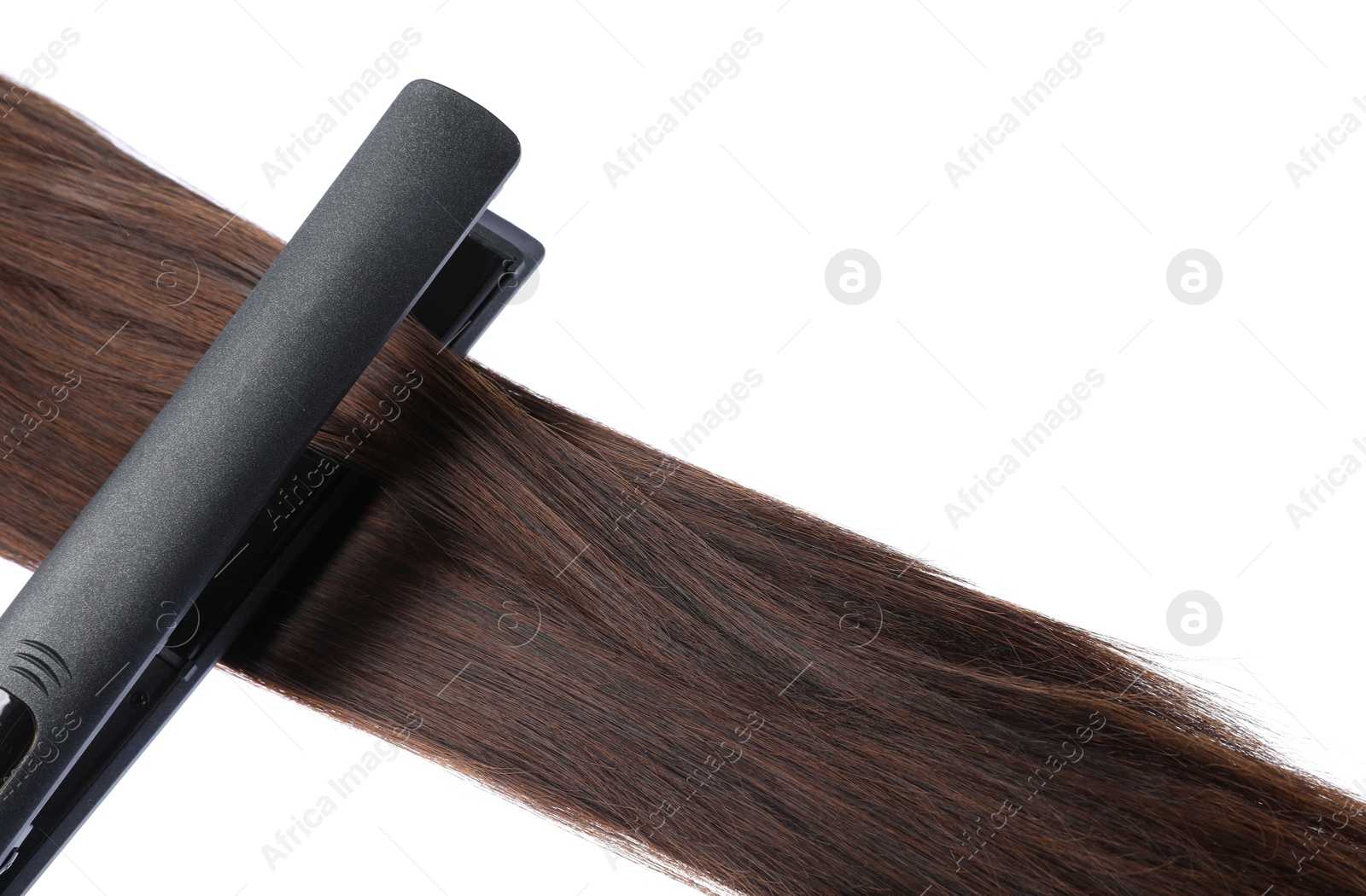Photo of Straightener with brown hair lock isolated on white