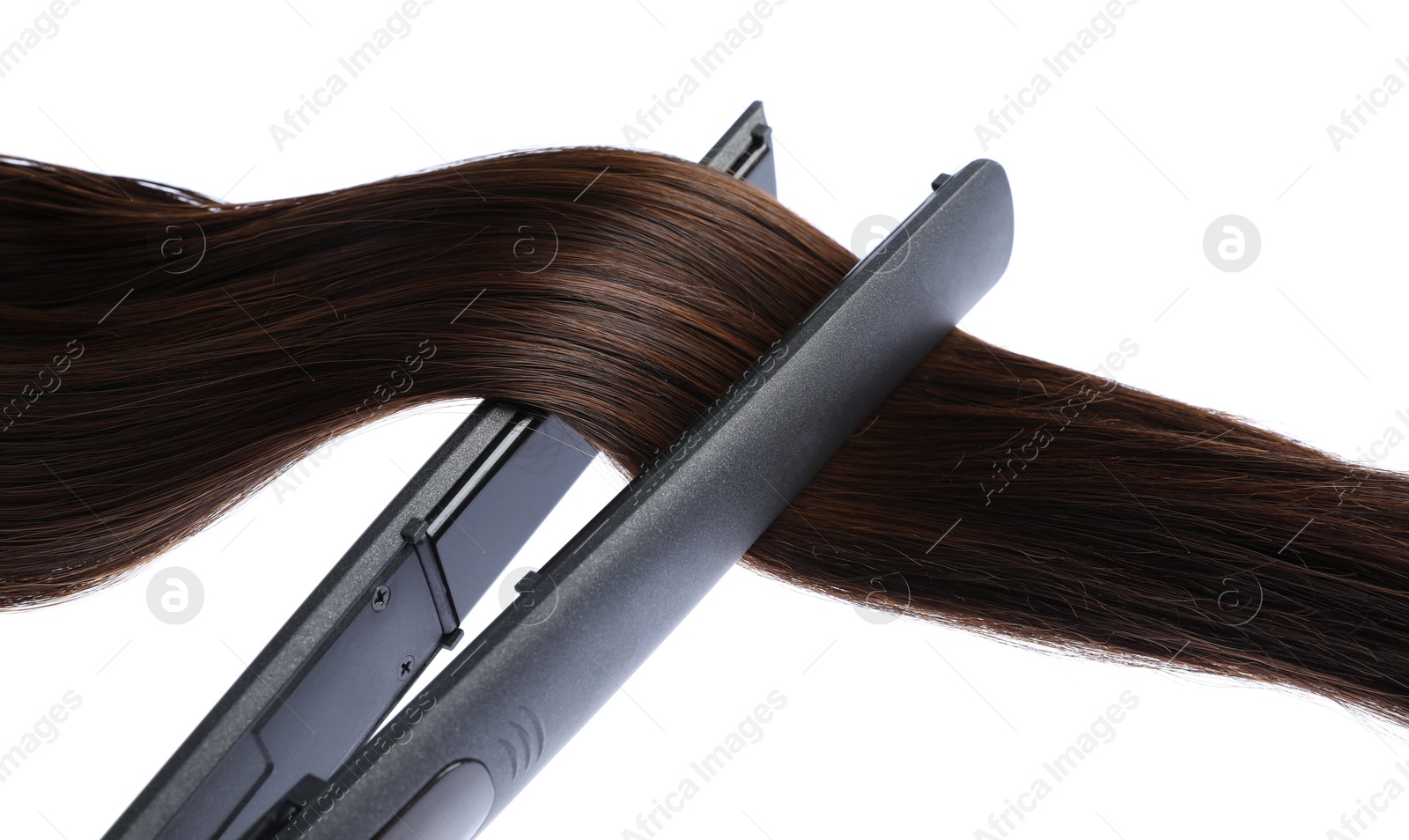 Photo of Straightener with brown hair lock isolated on white