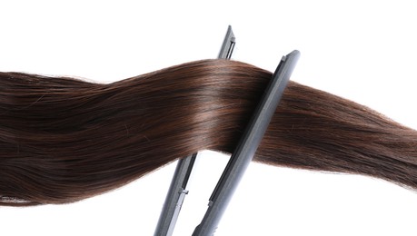 Photo of Straightener with brown hair lock isolated on white