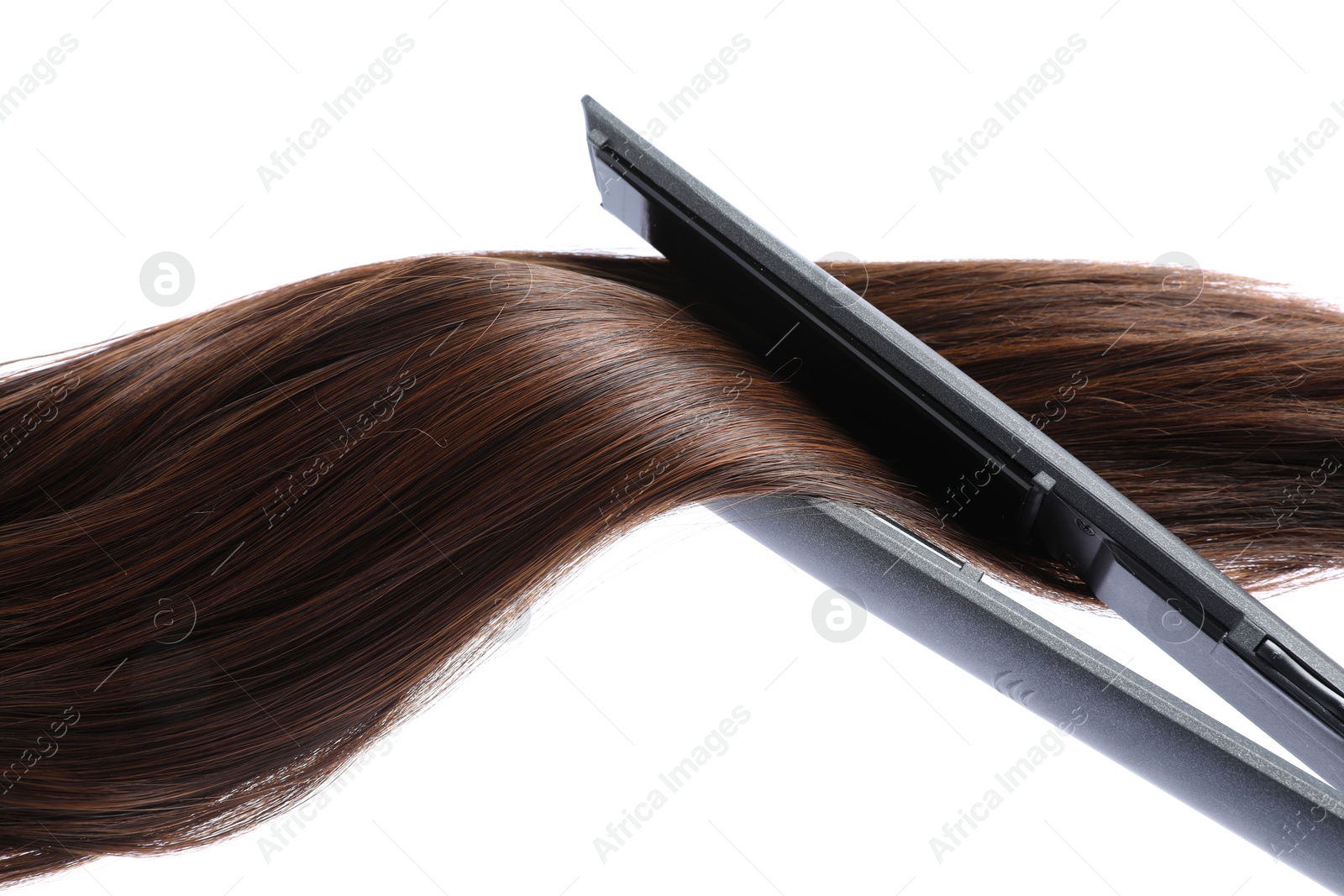Straightener with brown hair lock isolated on white Photo of Straightener with brown hair lock isolated on white