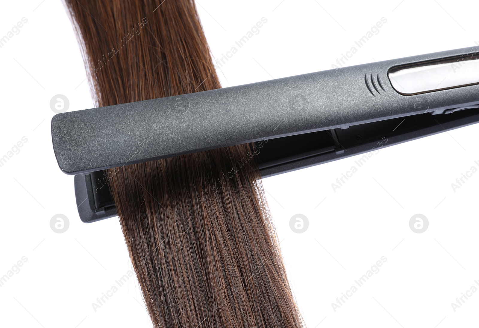 Straightener with brown hair lock isolated on white Photo of Straightener with brown hair lock isolated on white