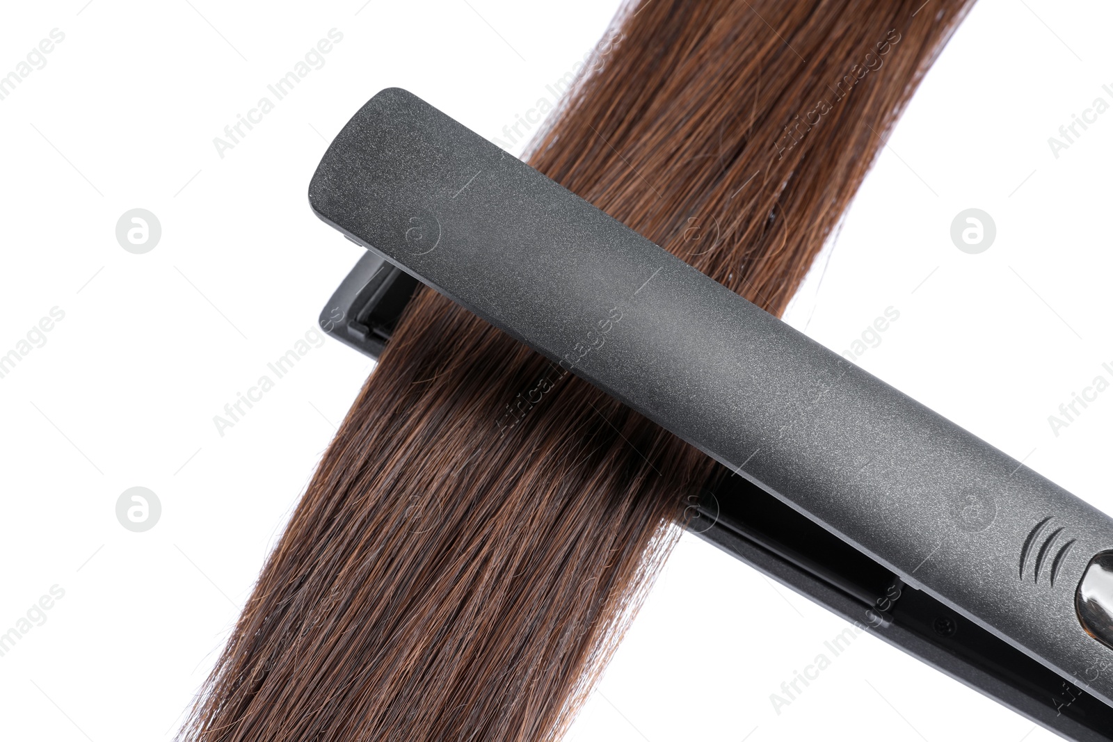 Photo of Straightener with brown hair lock isolated on white