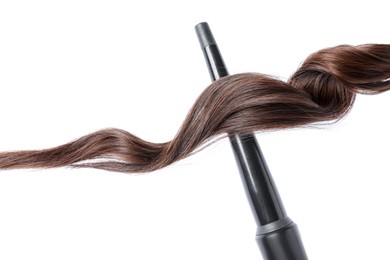 Photo of Curling iron with brown hair lock isolated on white