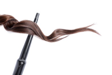 Photo of Curling iron with brown hair lock isolated on white